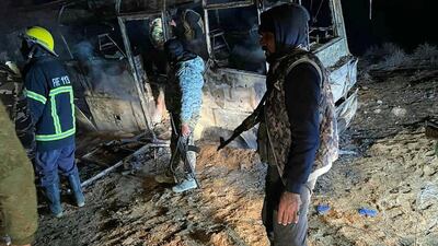 The scene of an attack targeting a bus transporting Syrian regime soldiers as they travelled home for holidays in the eastern province of Deir Ezzor on December 30, 2020. Sana / AFP