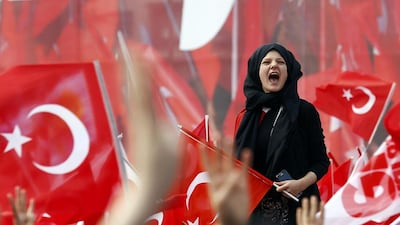 Supporters of Turkish President Tayyip Erdogan wave national flags during a rally for the upcoming referendum in Konya, Turkey. Umit Bektas / Reuters