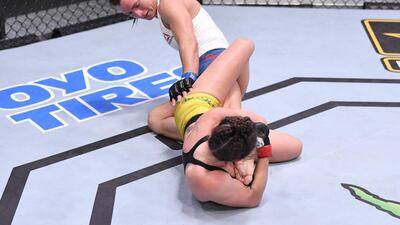 Mackenzie Dern (red gloves) secures a knee bar submission against Hannah Cifers (blue gloves) in their strawweight fight. Zuffa