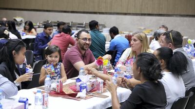 Muslims and Christians share iftar at St Andrew’s Church in Abu Dhabi on Wednesday night to show gratitude to Sheikh Zayed and celebrate the church's 50th anniversary. Pawan Singh / The National