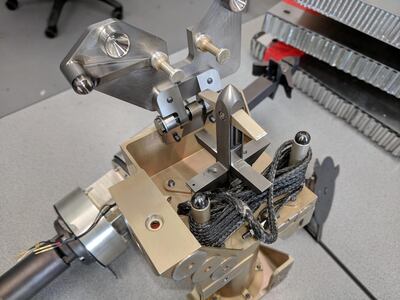 A small harpoon system, identical to the one in space now on the RemoveDebris satellite, is seen at the European Space Agency project on April 4. Stuart McDill / Reuters