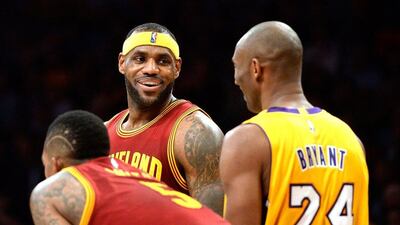 LeBron James, centre, laughs with Kobe Bryant during the Cavaliers' 109-102 win over the Lakers. Harry How / Getty Images