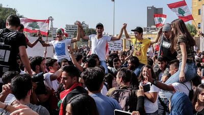Lebanese students from various schools wave national flags and shout slogans during ongoing anti-government protests in front of the Ministry of Education in Beirut. EPA