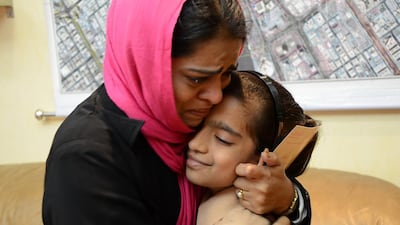Mother and her daughter are reunited by Al Naif Police after a three-year separation. Courtesy Dubai Police Department