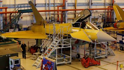 A member of staff works in the cockpit of an aircraft on the Eurofighter Typhoon production line at BAE systems Warton plant near Preston, northern England. Phil Noble / Reuters