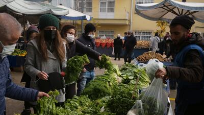 People buy food at a market in Ankara, Turkey. Annual inflation in Turkey hit 73.5 per cent in May, the highest rate since 1998. AP