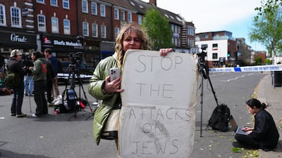 A woman holds a sign at the police cordon. Getty Images