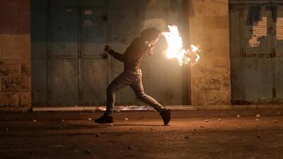 Palestinians throw molotov cocktail during clashes with Israeli security forces in the wake of a protest against US President Donald J. Trump's Middle East peace plan to solve the conflict between Palestinians and Israel, near the West Bank City of Hebron. EPA