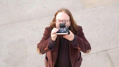 The author and photographer SF Said with his ancient Polaroid camera.