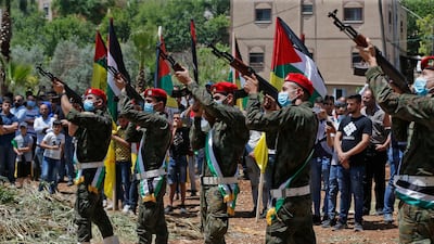 Palestinian special operations forces fire Kalashnikov assault rifles in salute for Ahmed Daraghmeh. AFP