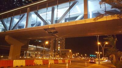 Damage to a bridge connecting three residential and commercial complexes on Reem Island led to the partial closure of two lanes on the road beneath it on Tuesday night. Thamer Al Subaihi/The National