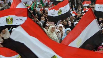 Egyptian women wave flags during a rally in Cairo's Tahrir square today in a protest against what they say are attempts by the country's military rulers to reinforce their powers.