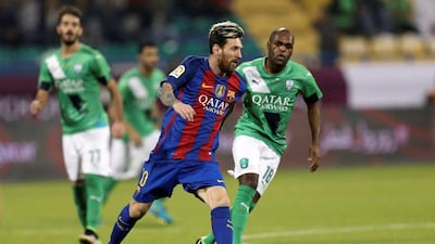 Lionel Messi gets away from Luiz Carlos. Ibraheem Al Omari / Reuters