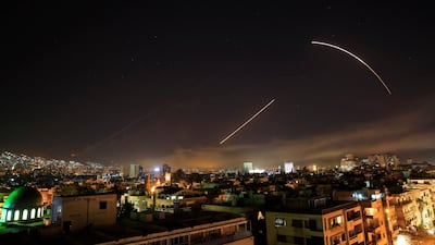 Missiles streak across the Damascus skyline as the US launches an attack on Syria targeting different parts of the capital, early Saturday, April 14, . Hassan Ammar / AP Photo