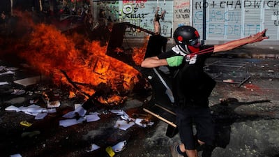 A demonstrator uses a slingshot during clashes with riot police in Santiago, Chile. AFP