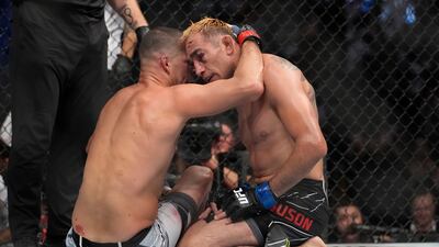 Nate Diaz embraces Tony Ferguson after Diaz won their welterweight bout at UFC 279. AP