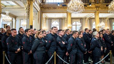Firefighters' brigade and security forces who took part at the fire extinguishing operations during the Notre Dame of Paris Cathedral fire, listen to French President Emmanuel Macron's speech at Elysee Palace in Paris, France, April 18, 2019. REUTERS