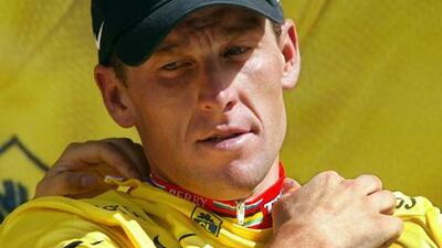 Lance Armstrong puts on the yellow jersey at the 2003 Tour de France. A new report reveals he tested positive four times during the 1999 race.