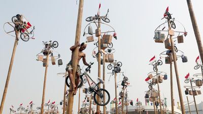 Indonesian participants climb greased poles to collect presents at a pole race during celebrations to mark the 74th anniversary of Indonesia's independence at the Jaya Ancol Dream Park in Jakarta, Indonesia. EPA
