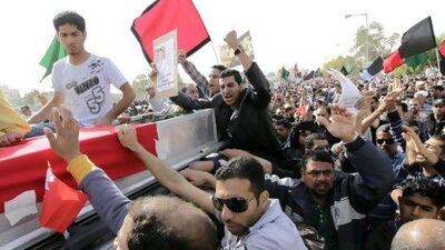 Friends and relatives chant anti-government slogans during the funeral of Mahmoud Maki Abu Taki, 22, who died during clashes between Bahraini anti-government protesters and riot police on Thursday. Hassan Ammar / AP Photo