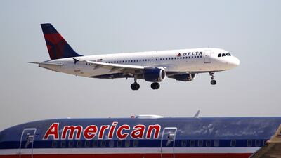 A Delta Airlines jet comes in for landing over an American Airlines jet at Dallas Fort Worth International Airport in Grapevine, Texas. LM Otero / AP Photo