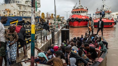 People from the town of Buzi unload from a boat at Beira Port. Getty Images