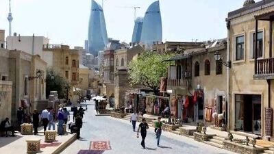 Baku's Old Town is a Unesco heritage site but gleaming new buildings are also cropping up, such as the Flame Towers, in the background. Joern Haufe / AP Photo