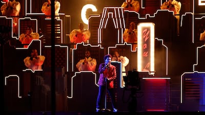 The Weeknd performs in his signature red blazer. EPA