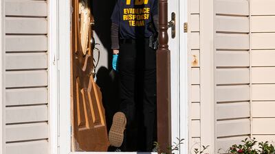 Members of the FBI search the home of suspected gunman Andre Bing. Getty Images / AFP