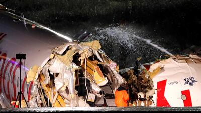 Firefighters douse the plane with water. Reuters