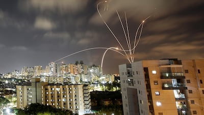Streaks of light are seen as Israel's Iron Dome anti-missile system intercepts rockets launched from the Gaza Strip towards Israel, as seen from Ashkelon, Israel May 12, 2021. Israel and Palestine are engaged in one of the most intense cross border conflicts. Reuters