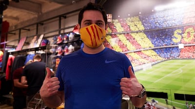 A man wearing a protective face mask poses during the presentation of official FC Barcelona brand masks. EPA