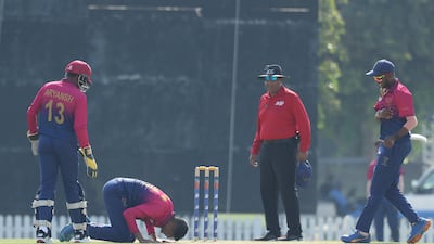 Dhruv Parashar of the UAE celebrates after taking a wicket.