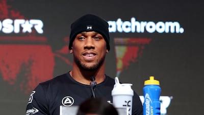 Anthony Joshua of Great Britain looks on from the top table. Getty Images