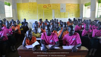 South Sudanese pupils at Liberty Primary School wait to meet with the Dubai Cares delegation to the Ayilo II refugee settlement in Northern Uganda. Dubai Cares partnered with Plan International to build new classrooms at the school for refugees. Roberta Pennington / The National