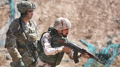 A US army trainer watches an Iraqi recruit at a military base in Taji, Iraq. Getty Images