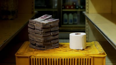 A roll of toilet paper is pictured next to 2,600,000 bolivars