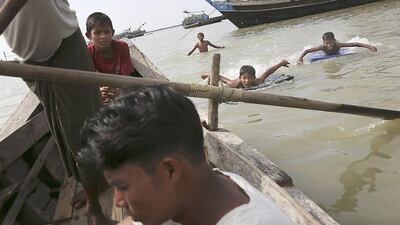 Children swim between Rohingya fishermen's boats at Thae Chaung refugee camp outside Sittwe, Myanmar, on November 8. Reuters