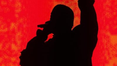 Kanye West performs in silhouette at the Bonnaroo Music and Arts Festival on Friday, June 13, 2014. AP