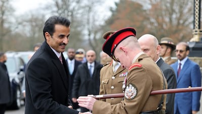 Sheikh Tamim greets military personnel. PA