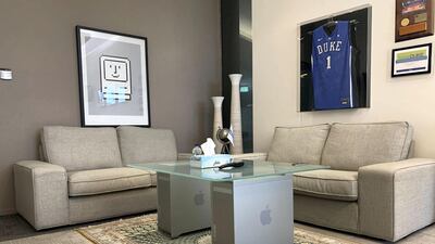 In Grewal's other office, Apple product cases are used to prop up a coffee table, and various Apple artefacts and photos are displayed on the wall. Cody Combs / The National