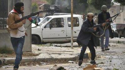 NTC fighters battle pro-Qaddafi forces in central Sirte yesterday as they attempt to take full control of the city and the country. Bela Szandelszky / AP Photo