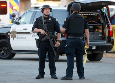 Police stand guard outside Gilroy High School following a shooting.San Jose Mercury News via AP