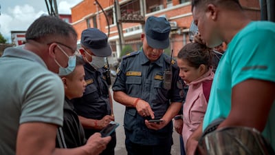 People speak to police outside Maharajgunj Medical Campus in Kathmandu, where unidentified bodies recovered from the floods are being taken. All photos: Getty Images