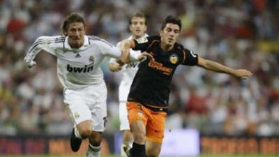 Real Madrid's Gabriel Heinze, left, fights for the ball with Valencia's David Villa during their Spanish Super Cup final second leg match at El Santiago Bernabeu.