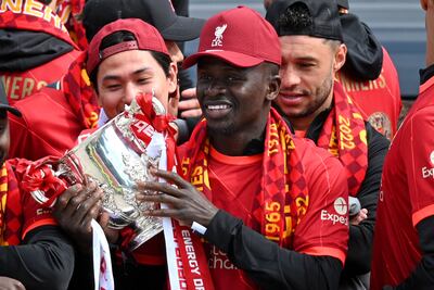 Sadio Mane with the League Cup during Liverpool's open-top bus parade at the end of last season. AFP