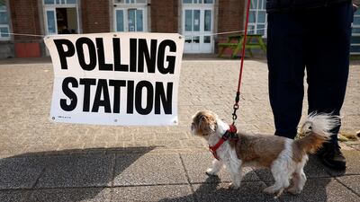 A dog stands outside a polling station in Blackpool. Reuters