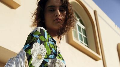 In motion: Blue floral dress, Dh2,197, Diane Von Furstenberg at The Outnet, silver robe, Dh552, Dima Ayad.