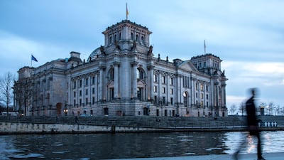 A man walks in front the Reichstag building, seat of the German parliament, in Berlin. Omer Messinger / EPA