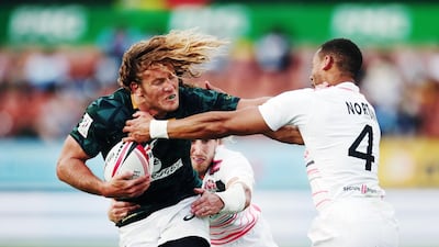 Werner Kok of South Africa fends off Dan Norton of England during the 2018 New Zealand Sevens at FMG Stadium in Hamilton, New Zealand. Anthony Au-Yeung / Getty Images